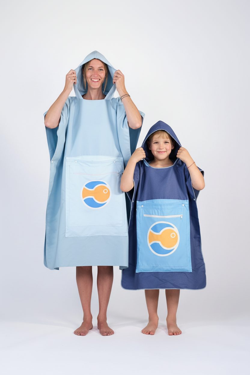 Mother and son from the front in Surfish ponchos on white background